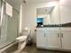 Well-lit bathroom with a glass-enclosed shower and a modern vanity with ample counter space at 9122 Sommerset Hills Dr, Davenport, FL 33896