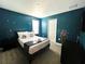 Whimsical, galaxy-themed bedroom with a double bed, and a TV for immersive entertainment at 9122 Sommerset Hills Dr, Davenport, FL 33896