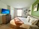 Comfortable bedroom with soft lighting, warm tones, plush bedding, and a flat-screen television at 9122 Sommerset Hills Dr, Davenport, FL 33896