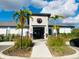 Beautiful clubhouse exterior with palm trees, manicured landscaping, and a pedestrian crossing sign at 9122 Sommerset Hills Dr, Davenport, FL 33896