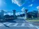 Grand entrance to a gated community featuring stone pillars and manicured landscaping under a bright blue sky at 9122 Sommerset Hills Dr, Davenport, FL 33896