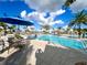 Relaxing community pool area, complete with tables and lounge chairs, for residents to enjoy on a sunny day at 9122 Sommerset Hills Dr, Davenport, FL 33896