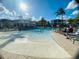 Large community pool with various seating options and palm trees, providing a perfect spot for relaxation and recreation at 9122 Sommerset Hills Dr, Davenport, FL 33896