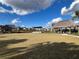 Spacious grassy community space with shaded cabanas, perfect for outdoor activities and relaxation at 9122 Sommerset Hills Dr, Davenport, FL 33896