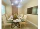 An elegant dining room with a glass table, seating for eight, and sophisticated decor creates a welcoming atmosphere at 9122 Sommerset Hills Dr, Davenport, FL 33896