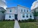 Beautiful modern two-story home with stone facade, manicured lawn, and front entry door at 9122 Sommerset Hills Dr, Davenport, FL 33896