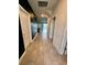 A well-lit hallway with tile flooring leading to a view of the pool at 9122 Sommerset Hills Dr, Davenport, FL 33896