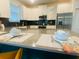 A modern kitchen with stainless steel appliances, granite countertops, and white cabinetry provides a stylish cooking space at 9122 Sommerset Hills Dr, Davenport, FL 33896