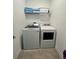 Well-equipped laundry room features modern appliances and ample shelving for storage at 9122 Sommerset Hills Dr, Davenport, FL 33896
