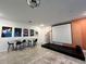 Open living area includes stage, screen, barstool seating, and contemporary decor at 9122 Sommerset Hills Dr, Davenport, FL 33896