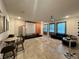 Spacious living room features a projector screen, barstool seating, and comfortable modern furniture at 9122 Sommerset Hills Dr, Davenport, FL 33896