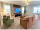 Bright living room features contemporary decor, neutral tones, and a large television at 9122 Sommerset Hills Dr, Davenport, FL 33896