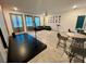 Spacious living room includes tile floors, modern lighting, projector screen, stage and comfortable seating at 9122 Sommerset Hills Dr, Davenport, FL 33896