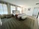 Serene main bedroom with a king bed, large windows, and elegant decor at 9122 Sommerset Hills Dr, Davenport, FL 33896