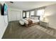 Spacious main bedroom with a king bed, bench, TV, and bright natural light at 9122 Sommerset Hills Dr, Davenport, FL 33896