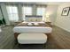 Inviting main bedroom features a plush king bed, bench, and soft neutral tones at 9122 Sommerset Hills Dr, Davenport, FL 33896