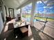Outdoor dining area on the patio with view of the screened-in pool and spa at 9122 Sommerset Hills Dr, Davenport, FL 33896