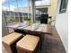 Outdoor dining on a covered patio, complete with grill, seating, and table setting at 9122 Sommerset Hills Dr, Davenport, FL 33896