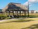 Picturesque palapa featuring seating and a tranquil setting, perfect for relaxing and enjoying the outdoors at 9122 Sommerset Hills Dr, Davenport, FL 33896