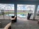 Covered patio offers relaxing seating and view of the screened-in pool area at 9122 Sommerset Hills Dr, Davenport, FL 33896