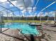 Inviting pool and spa with sun loungers under a screened enclosure, perfect for relaxation and enjoying the outdoors at 9122 Sommerset Hills Dr, Davenport, FL 33896
