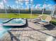 Beautiful spa with sun loungers inside screened enclosure, ideal for unwinding and enjoying sunshine at 9122 Sommerset Hills Dr, Davenport, FL 33896
