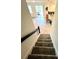 Carpeted stairs lead to an open living area with kitchen views and outdoor access, providing seamless indoor-outdoor flow at 9122 Sommerset Hills Dr, Davenport, FL 33896