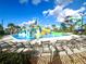 Thrilling water park features a large slide and lounge chairs, offering fun and relaxation for residents at 9122 Sommerset Hills Dr, Davenport, FL 33896