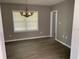 A dining room is illuminated by a chandelier, ready for gatherings and everyday meals at 100 Avenue K Ne, Winter Haven, FL 33881