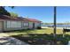 Street view of a well-maintained one-story home with a front yard and water views at 100 Avenue K Ne, Winter Haven, FL 33881