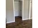 Hallway featuring updated flooring, fresh paint, and doors leading to various rooms at 100 Avenue K Ne, Winter Haven, FL 33881