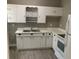 Clean kitchen featuring white cabinets, countertops, and modern appliances, perfect for cooking at 100 Avenue K Ne, Winter Haven, FL 33881