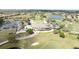 Aerial view of the clubhouse near a golf course, parking and homes in a beautifully landscaped community at 10731 Belfry Cir, Orlando, FL 32832