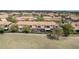 Aerial view of residences overlooking a golf course and waterway at 10731 Belfry Cir, Orlando, FL 32832