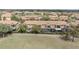 Aerial view of a luxurious pool, residences, and a nearby waterway at 10731 Belfry Cir, Orlando, FL 32832