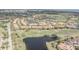 Stunning aerial view of the community featuring lush landscaping, a golf course, and scenic ponds at 10731 Belfry Cir, Orlando, FL 32832