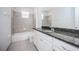Bathroom showcasing granite counters, tile flooring, and a shower-tub combination at 10731 Belfry Cir, Orlando, FL 32832