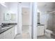Bathroom featuring double vanity with granite countertop and glass enclosed shower at 10731 Belfry Cir, Orlando, FL 32832