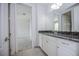 Bright bathroom featuring granite counters, white cabinets, and a tiled floor at 10731 Belfry Cir, Orlando, FL 32832