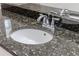 Close up of a bathroom vanity featuring granite counters, a sink, and a chrome faucet at 10731 Belfry Cir, Orlando, FL 32832
