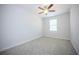 Cozy bedroom featuring a ceiling fan, window with blinds, and soft carpet at 10731 Belfry Cir, Orlando, FL 32832
