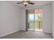 Bedroom featuring neutral carpet, ceiling fan and sliding glass doors to the outside balcony at 10731 Belfry Cir, Orlando, FL 32832