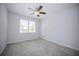 Neutral bedroom with a ceiling fan, window with blinds, and plush carpeting at 10731 Belfry Cir, Orlando, FL 32832