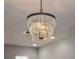 Close up view of a modern crystal chandelier with tiered design at 10731 Belfry Cir, Orlando, FL 32832