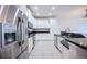 Modern kitchen featuring stainless steel appliances, white cabinets, and granite countertops at 10731 Belfry Cir, Orlando, FL 32832