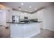 Modern kitchen featuring white cabinets, stainless steel appliances, and a breakfast bar with granite countertops at 10731 Belfry Cir, Orlando, FL 32832
