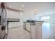 Modern kitchen with white cabinetry, granite countertops, and stainless steel appliances, open to the living area at 10731 Belfry Cir, Orlando, FL 32832