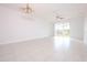 Spacious living room featuring tile flooring, sliding glass doors, and a modern ceiling fan at 10731 Belfry Cir, Orlando, FL 32832