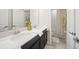 Bathroom with double sinks, vanity, and a shower with a patterned shower curtain at 1107 Trappers Trail Loop, Davenport, FL 33896