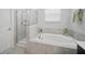 Bathroom featuring a soaking tub with decorative accents and a separate tiled shower at 1107 Trappers Trail Loop, Davenport, FL 33896